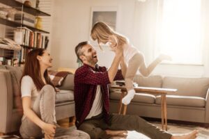 Family Sitting On Living Room Floor