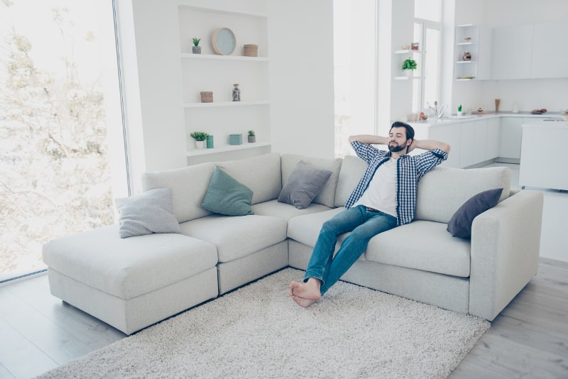 man relaxing on couch